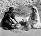 Palestine: Two Palestinian women grinding wheat, c. 1920